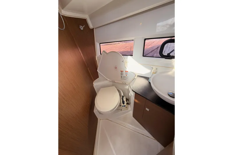  Yacht Photos Pics 2020 Jeanneau NC 895 boat bathroom with toilet, sink, and window.
