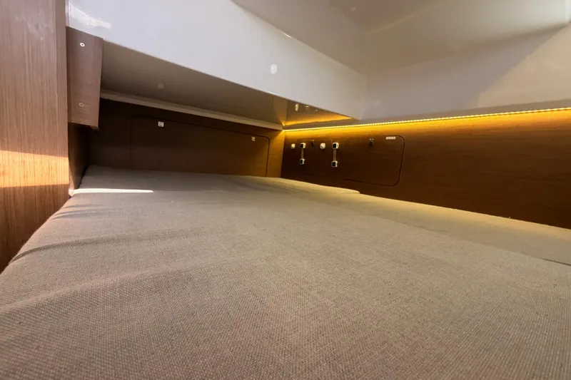  Yacht Photos Pics 2020 Jeanneau NC 895 cabin interior with cozy bed and ambient lighting.