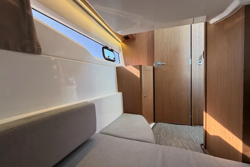  Yacht Photos Pics 2020 Jeanneau NC 895 cabin interior with modern wood finish and seating.