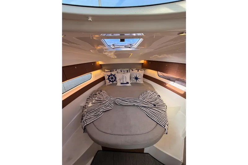  Yacht Photos Pics Cozy interior cabin of 2020 Jeanneau NC 895 with nautical-themed decor.