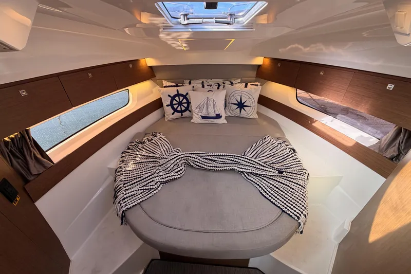  Yacht Photos Pics Luxurious interior cabin of 2020 Jeanneau NC 895 with nautical-themed decor.