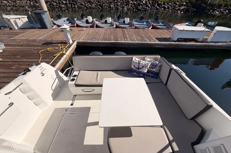  Yacht Photos Pics Cozy seating area on 2020 Jeanneau NC 895 boat docked at marina.