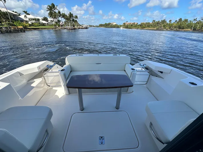 Aeronautical Yacht Photos Pics 2022 Tiara Yachts C39 Coupe deck with seating, table, and scenic water view.