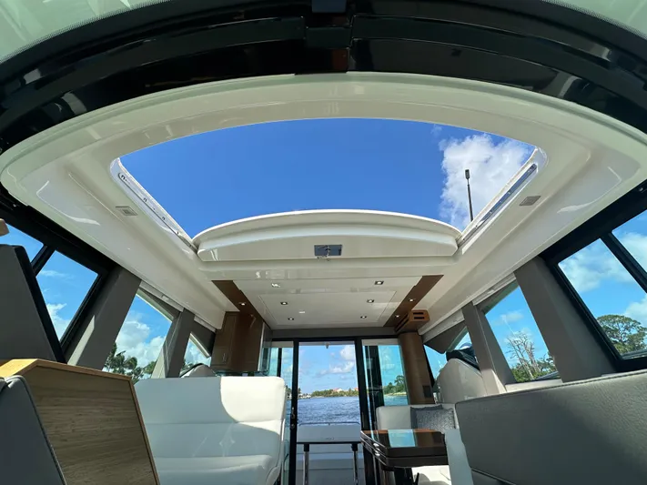 Aeronautical Yacht Photos Pics Interior view of 2022 Tiara Yachts C39 Coupe with open sunroof and modern seating.