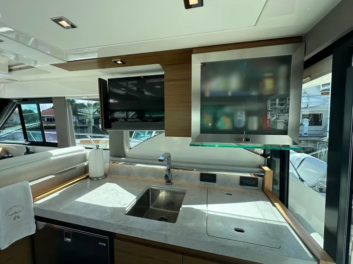 Aeronautical Yacht Photos Pics Interior of 2022 Tiara Yachts C39 Coupe, featuring modern kitchen with sink and cabinets.