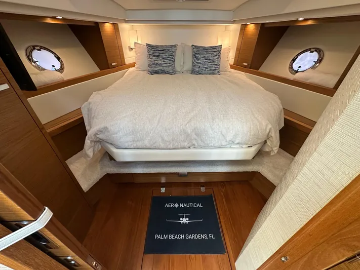Aeronautical Yacht Photos Pics Luxurious 2022 Tiara Yachts C39 Coupe cabin with cozy bed and elegant wood finish.