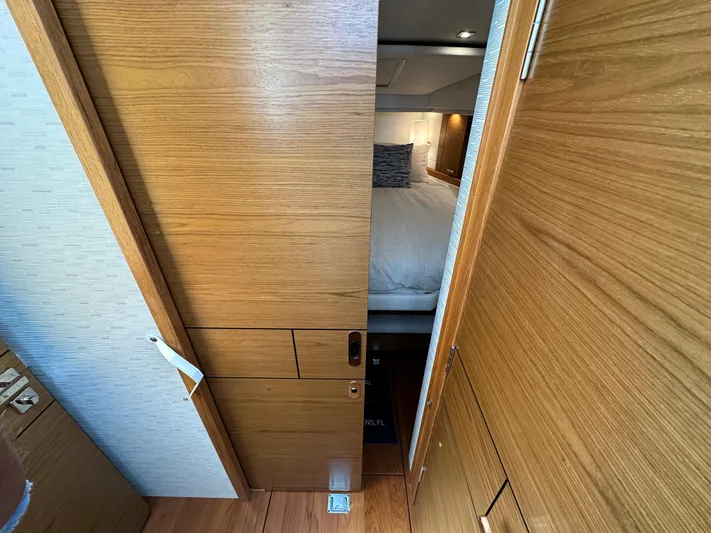Aeronautical Yacht Photos Pics 2022 Tiara Yachts C39 Coupe interior cabin with wooden door and cozy bed.