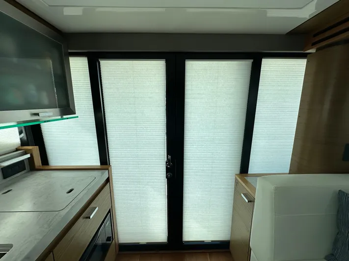 Aeronautical Yacht Photos Pics Interior of 2022 Tiara Yachts C39 Coupe with modern kitchen and window blinds.