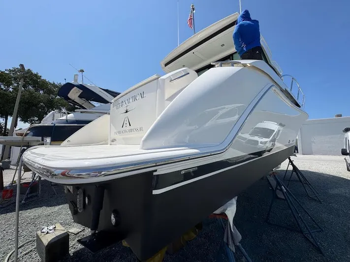Aeronautical Yacht Photos Pics 2022 Tiara Yachts C39 Coupe, sleek design, docked outdoors under clear blue sky.