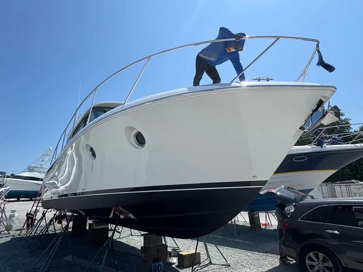 Aeronautical Yacht Photos Pics 2022 Tiara Yachts C39 Coupe being cleaned on dry dock under clear blue sky.
