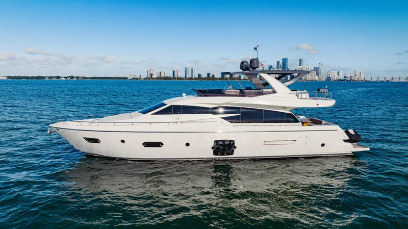 Sami Kay III Yacht Photos Pics 2017 Ferretti Yachts 750 cruising on open water with city skyline in background.