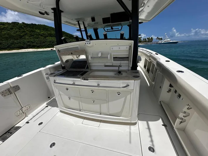  Yacht Photos Pics 2020 Boston Whaler 380 Outrage boat interior with fishing station, ocean view, and island backdrop.