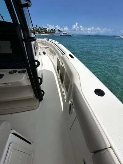  Yacht Photos Pics 2020 Boston Whaler 380 Outrage on clear blue water, sunny day, palm trees in background.