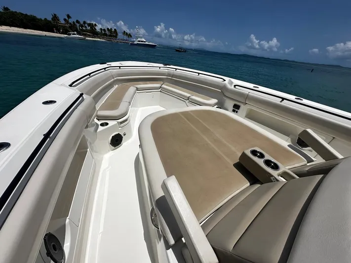 Yacht Photos Pics 2020 Boston Whaler 380 Outrage boat interior with seating, ocean view, and distant island.