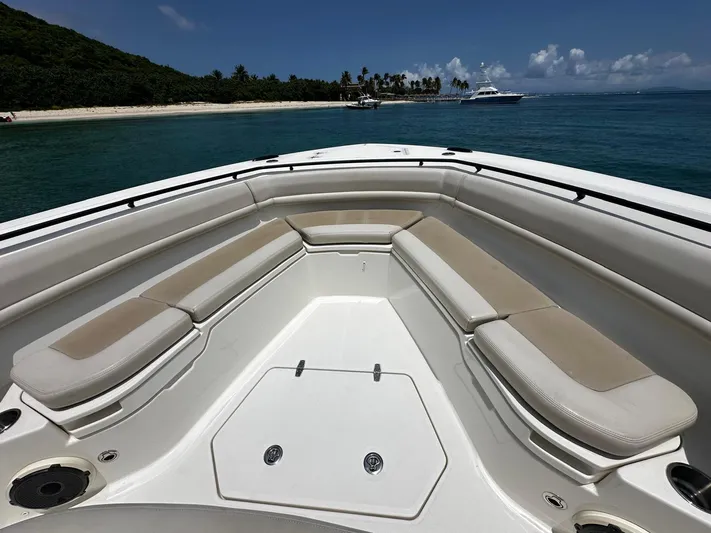  Yacht Photos Pics 2020 Boston Whaler 380 Outrage boat interior with cushioned seating, near tropical island.