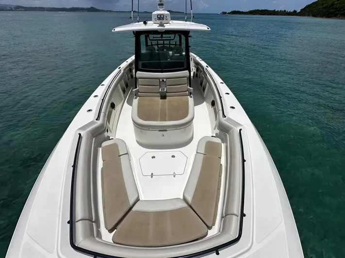  Yacht Photos Pics Boston Whaler 380 Outrage 2020 boat on calm water, featuring spacious seating and sleek design.
