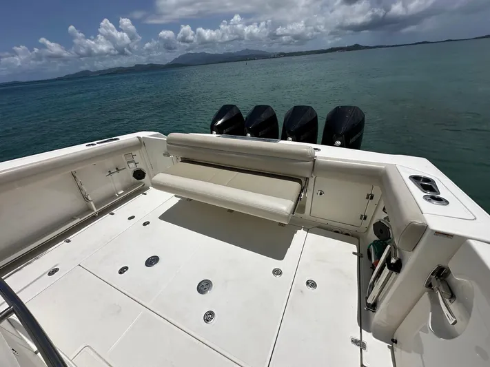  Yacht Photos Pics 2020 Boston Whaler 380 Outrage boat deck with seating, ocean view, and four engines.