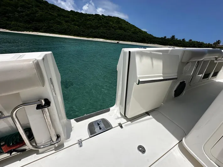  Yacht Photos Pics Boston Whaler 380 Outrage 2020 boat with open side door, near tropical shoreline.