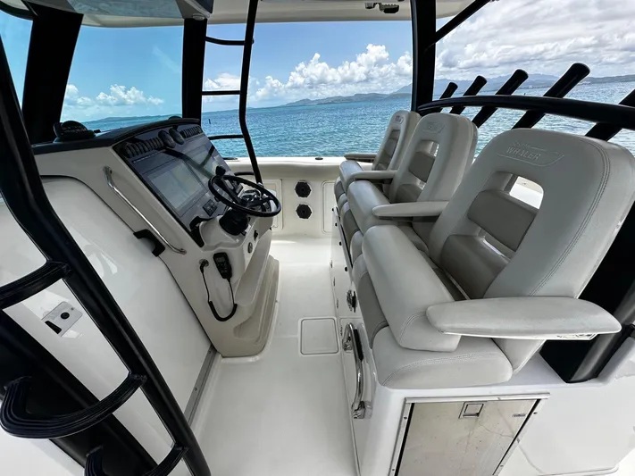  Yacht Photos Pics Boston Whaler 380 Outrage 2020 helm with dual seats, ocean view in background.