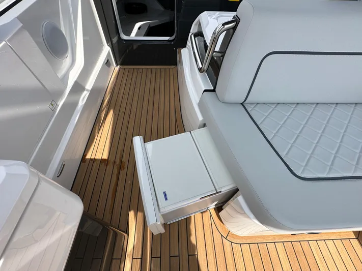 '23 Fairline Fline 33 Ob Yacht Photos Pics 2023 Fairline F//Line 33 Outboard interior with teak flooring and pull-out storage.