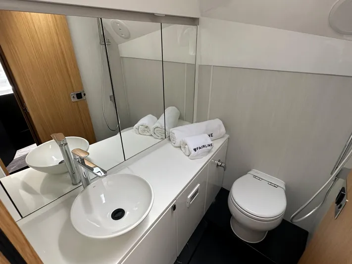 '23 Fairline Fline 33 Ob Yacht Photos Pics Modern bathroom in 2023 Fairline F//Line 33 Outboard yacht with sink, toilet, and mirror.