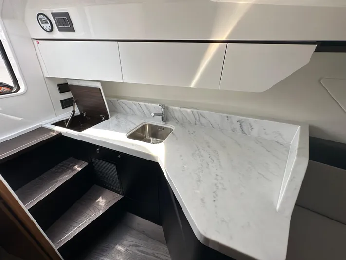 '23 Fairline Fline 33 Ob Yacht Photos Pics 2023 Fairline F//Line 33 Outboard yacht interior kitchen with marble countertop and sink.