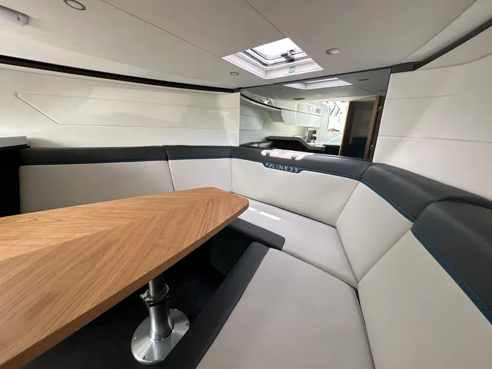 '23 Fairline Fline 33 Ob Yacht Photos Pics Interior of 2023 Fairline F//Line 33 Outboard yacht with modern seating and wooden table.