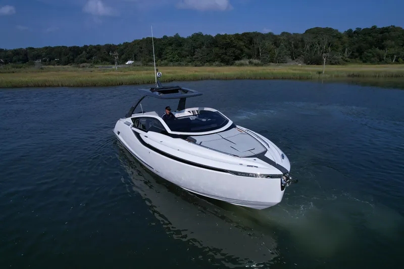 '23 Fairline Fline 33 Ob Yacht Photos Pics 2023 Fairline F//Line 33 Outboard luxury motor yacht cruising on a serene lake.