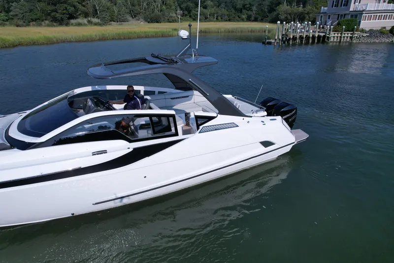 '23 Fairline Fline 33 Ob Yacht Photos Pics 2023 Fairline F//Line 33 Outboard luxury yacht cruising on a serene waterway.