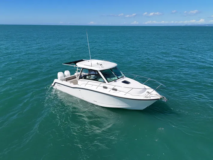  Yacht Photos Pics 2015 Boston Whaler 315 Conquest boat cruising on open sea under clear skies.