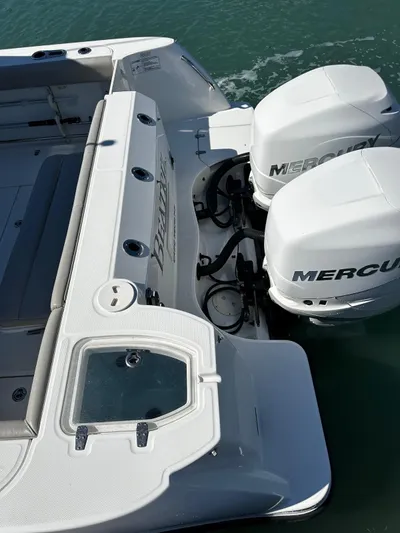  Yacht Photos Pics 2015 Boston Whaler 315 Conquest with dual Mercury outboard engines on calm water.