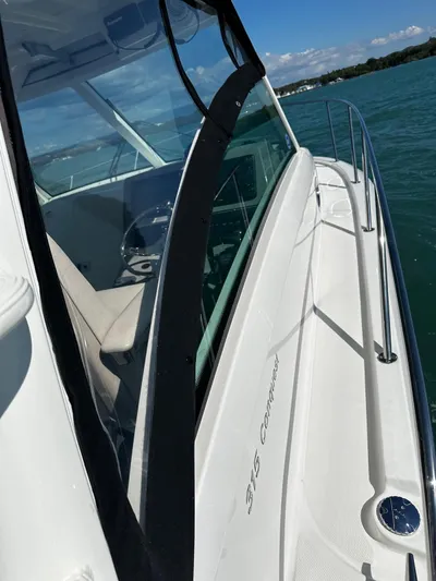 Yacht Photos Pics 2015 Boston Whaler 315 Conquest boat on water, showcasing sleek design and spacious deck.