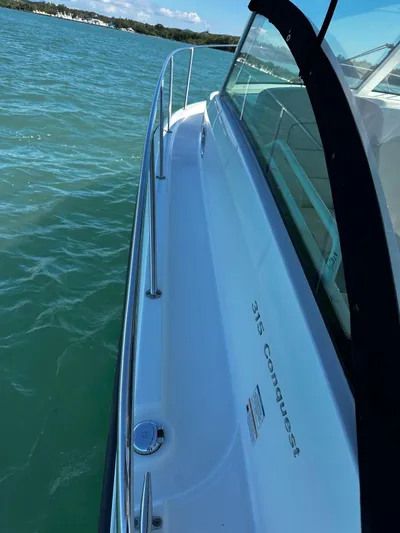  Yacht Photos Pics 2015 Boston Whaler 315 Conquest boat on water, side view.