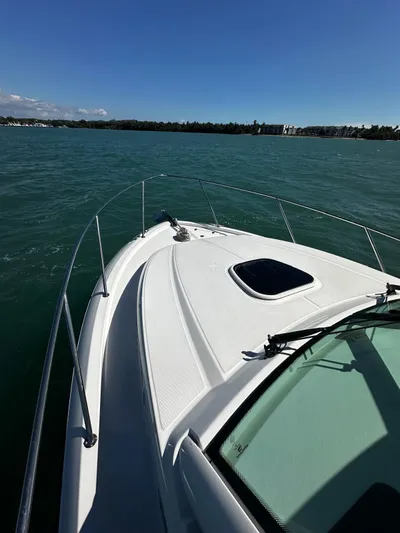  Yacht Photos Pics 2015 Boston Whaler 315 Conquest cruising on open water under clear blue skies.