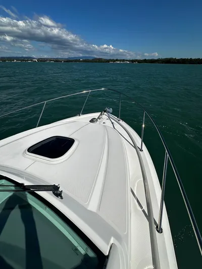  Yacht Photos Pics 2015 Boston Whaler 315 Conquest boat on calm water under clear blue sky.