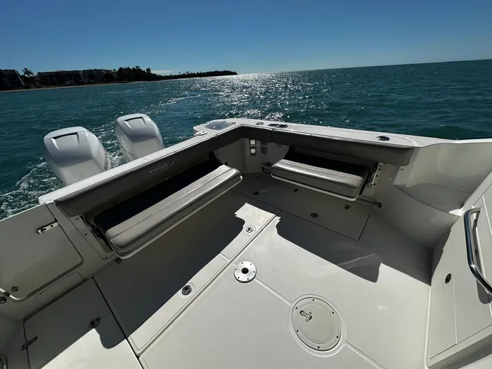  Yacht Photos Pics 2015 Boston Whaler 315 Conquest boat deck with seating, ocean view, and twin engines.