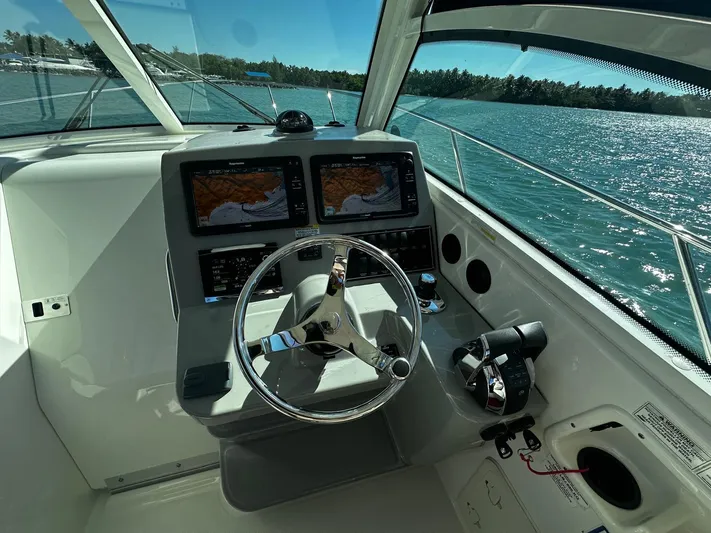  Yacht Photos Pics Cockpit of 2015 Boston Whaler 315 Conquest with dual navigation screens and steering wheel.