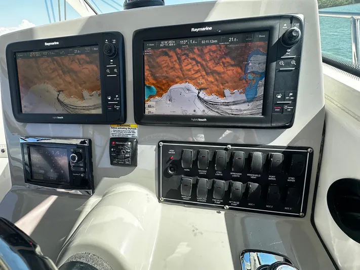  Yacht Photos Pics Control panel of a 2015 Boston Whaler 315 Conquest with navigation screens.