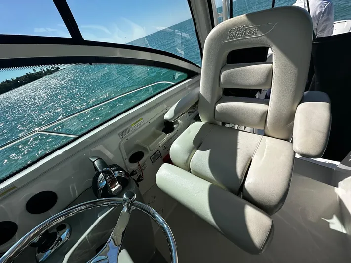  Yacht Photos Pics 2015 Boston Whaler 315 Conquest helm seat with ocean view and steering wheel.