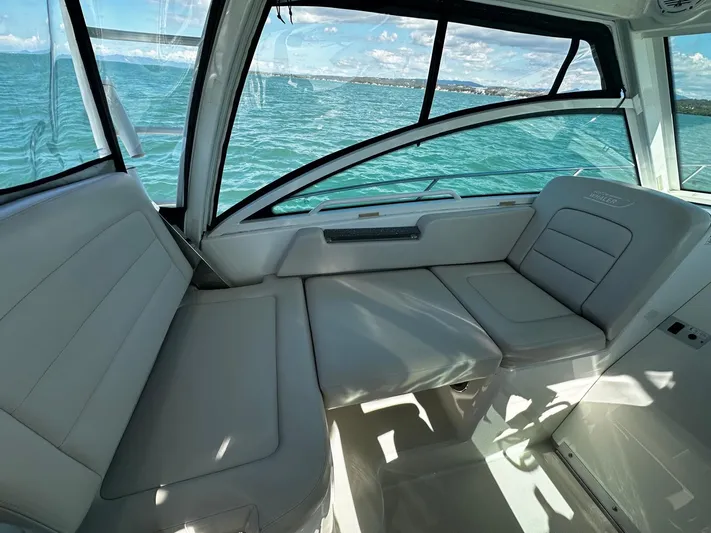  Yacht Photos Pics Interior view of 2015 Boston Whaler 315 Conquest boat with seating, overlooking the ocean.