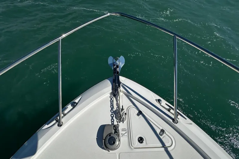  Yacht Photos Pics Bow view of 2015 Boston Whaler 315 Conquest on water, featuring anchor and railing.