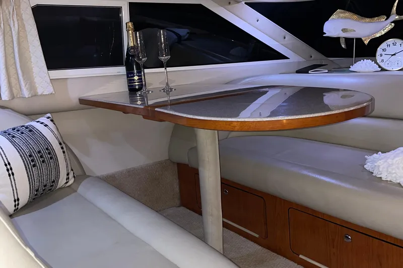 Yacht Photos Pics Luxurious interior of 2000 Sea Ray 400 Sedan Bridge with elegant dining area.