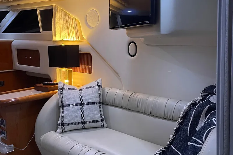  Yacht Photos Pics Luxurious interior of 2000 Sea Ray 400 Sedan Bridge with cozy seating and ambient lighting.