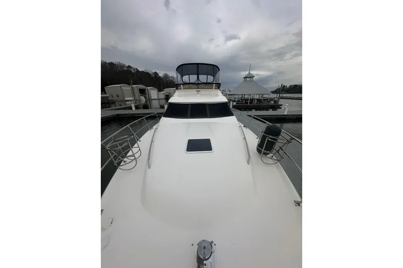  Yacht Photos Pics 2000 Sea Ray 400 Sedan Bridge yacht docked at marina under cloudy sky.