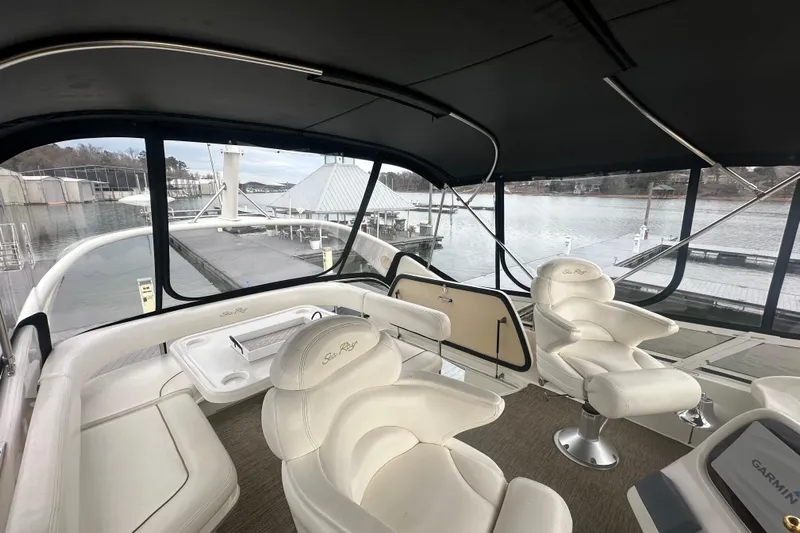  Yacht Photos Pics Luxurious interior of 2000 Sea Ray 400 Sedan Bridge yacht with plush seating and panoramic windows.