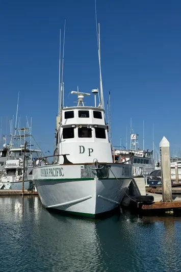 Daiwa Pacific Yacht Photos Pics 1966 Seaway Commercial Sportfish Vessel docked in marina under clear blue sky.