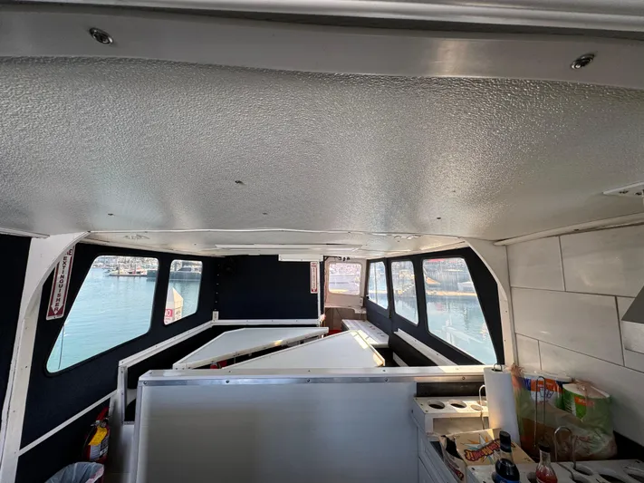 Daiwa Pacific Yacht Photos Pics Interior of a 1966 Seaway Commercial Sportfish Vessel, featuring windows and storage areas.