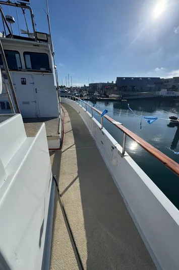 Daiwa Pacific Yacht Photos Pics 1966 Seaway Commercial Sportfish Vessel docked, showcasing side deck and marina view.