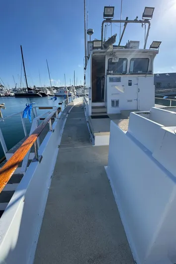 Daiwa Pacific Yacht Photos Pics 1966 Seaway Commercial Sportfish Vessel docked, showcasing side deck and cabin in a marina setting.