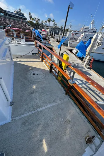 Daiwa Pacific Yacht Photos Pics 1966 Seaway Commercial Sportfish Vessel docked at marina, featuring wooden railings and clear skies.